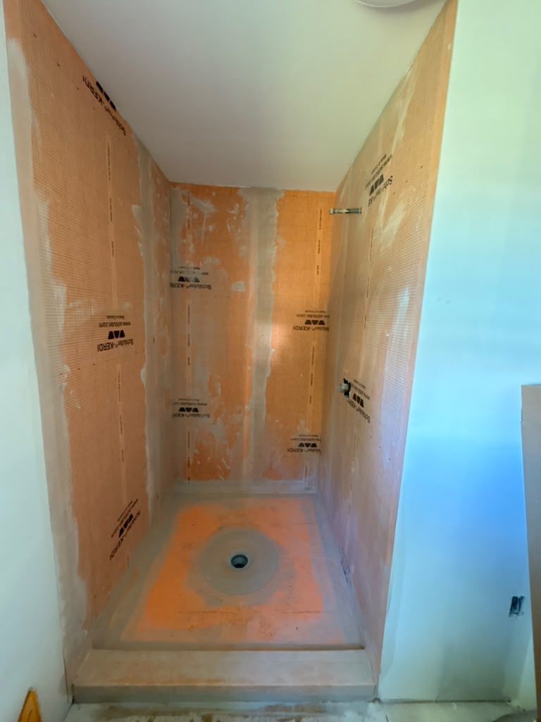 Waterproofed walk-in shower ready for tile